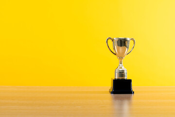 golden trophy on wooden table