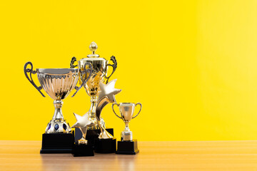 group of trophies on wooden table