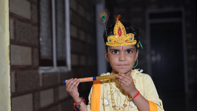 Asian boy posing as Shri krishna or kanhaiya on fancy dress at Gokulashtami festival.