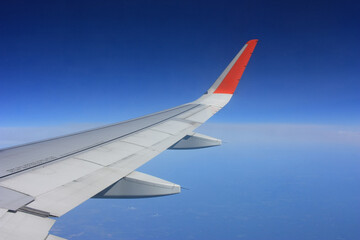 Airplane flies in the blue sky