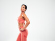 © halayalex - Tanned fitness woman in pink sports clothing. Sexy young beautiful model with perfect body.Female isolated on grey background in studio. Stretching out before training