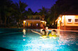 © famveldman - Kids in swimming pool at night