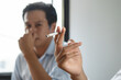 passive smoking effect, person cover his nose and avoid smoker near him
