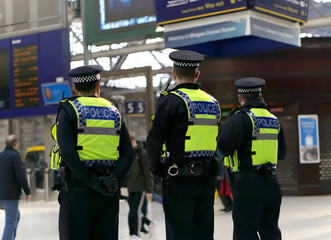 Police officer on duty on a city centre street during special event. 