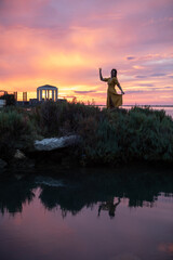 Wall Mural - silhouette of the woman on sunset at sea beach