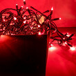 Christmas Lights. Isolated. Red background. Stock Image.