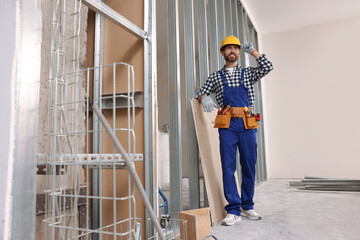 Sticker - Professional builder in uniform with tool belt indoors