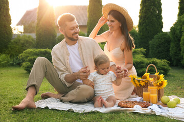 Canvas Print - Happy family having picnic in garden on sunny day