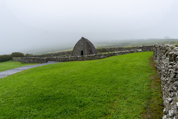 Wall Mural - landscape view of the Gallarus Oratory early-Christian church in County Kerry on a foggy morning