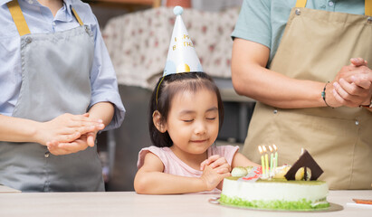 Young Asian family, birthday party