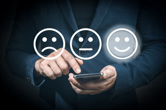 Wall Mural -  - Businessman pressing excellent smiley face rating icon over dark blue background, customer service evaluation and feedback rating. costumer review concept, man using phone chooses happy smiling face
