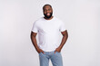 © deagreez - Photo of cute charming man wear casual t-shirt smiling arms pockets isolated white color background