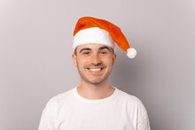 A Portrait Of A Young Man Wearing A Christmas Hat
