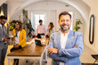 © Zoran Zeremski - Portrait of smiling businessman in office working with his colleagues.