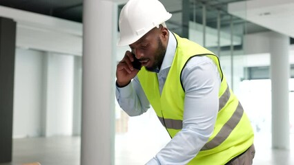Aufkleber - Construction worker, building contractor or engineer talking on a phone while working on a build site. Young male builder answering a call while planning a renovation, remodel or new development