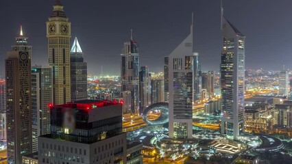 Sticker - Skyscrapers on Sheikh Zayed Road and DIFC durind all night timelapse in Dubai, UAE. Towers in financial centre aerial view from above with lights turning off