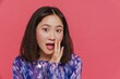 Portrait of young asian cute girl covering her opened mouth