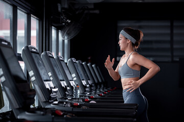 Young Fitness sport people wearing sportwear with workout headband under exercise on treadmill machine gym is sport healthy body building in fitness lifestyle.