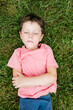 © ADDICTIVE STOCK - Boy with eyes closed lying on grass