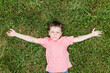 © ADDICTIVE STOCK - Boy lying on grass looking at camera
