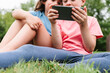 © ADDICTIVE STOCK - Anonymous siblings using smartphone together in park