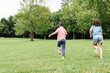 © ADDICTIVE STOCK - Kids running on lawn in park