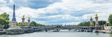 Pont Alexandre III Bridge, Eiffel Tower And The Seine River In Paris, France
