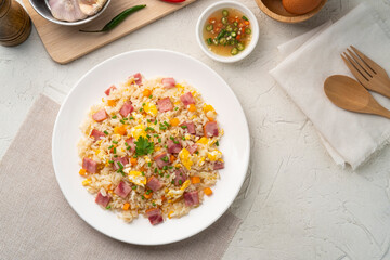 Wall Mural - Thai Fried rice with egg and sliced ham carrot in white plate.Easy cooking food.Top view