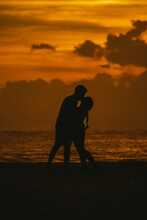 Anonymous Loving Couple Kissing On Beach At Sunset