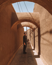Serious Guy Standing In Arched Passage During Sightseeing Trip In Kerman