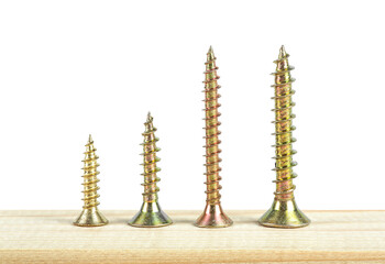 Poster - Golden screws on wooden plank isolated on a white background