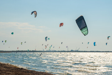 Lots of kites. Sea coast, in the coastal zone there are many extreme sports athletes