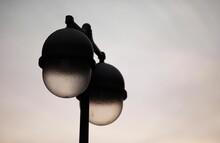 Closeup Of Street Lamps Against Cloudy Sky