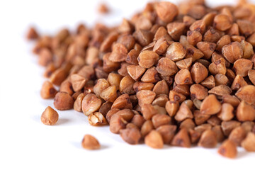 Wall Mural - Pile of buckwheat seeds isolated on white background, closeup