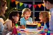 © famveldman - Child birthday party cake. Family with kids.