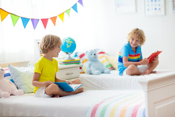 Wall Mural - Child reading in bed. Kids read. Boy at home.