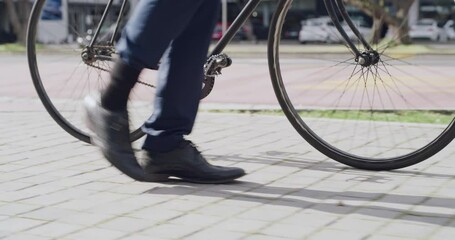 Poster - Business man walking in city with bike, commuting to work or traveling in morning routine in town. Closeup legs or feet of entrepreneur in travel, trip or commute with eco friendly transport solution