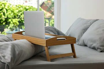 Poster - Wooden tray table with laptop on bed indoors