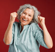 © Kay A/peopleimages.com - Celebrating, cheering and winning with a happy, smiling and excited senior female posing in studio against a red background. Portrait of a cheerful, wow and positive mature female with a fist gesture