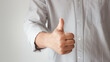 © THAWEERAT - Businessman showing OK approve or like signal with thumb raise up. Successful concept. Business man shows thumb up sign gesture. Businessman showing thumbs up - closeup shot.