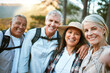 © Courtney Haas/peopleimages.com - Hiking team taking a selfie in the natural woods, mountains and forest outdoors together in nature. Healthy, happy and senior couples outside on holiday to keep active, friendship and fit on a hike