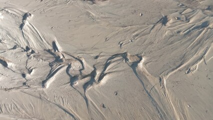 Dirty wet sand, grunge horizontal shabby background close-up. Blurry image of sand pattern. Abstract nature background.