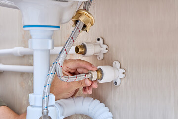 Wall Mural - Connecting faucet on sink in bathroom with domestic plumbing system.