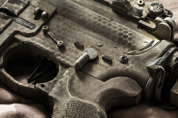 Wall Mural - Close-up shot of selective fire of khaki camouflage M4 assault rifle, to be adjusted to fire in safe, semi-automatic, fully automatic firearm
