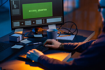 Poster - cybercrime, hacking and technology concept - close up of male hacker in dark room writing code or us