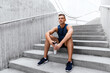 © Syda Productions - fitness, sport and people concept - tired young man with bottle of water sitting on stairs