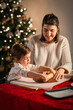 © Syda Productions - family, cooking and winter holidays concept - happy mother and baby daughter with rolling pin making gingerbread cookies from dough at home on christmas