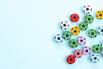 Wall Mural - Wooden figures in the form of soccer balls on a blue background. Football time.