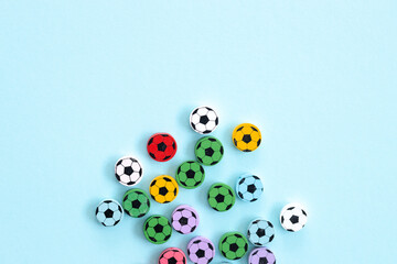 Wall Mural - Wooden figures in the form of soccer balls on a blue background. Football time.