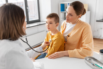 Canvas Print - medicine, healthcare and pediatry concept - happy smiling mother with little son and doctor with stethoscope at clinic